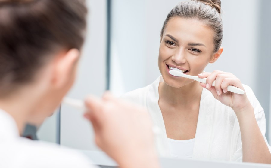 woman brushing teeth