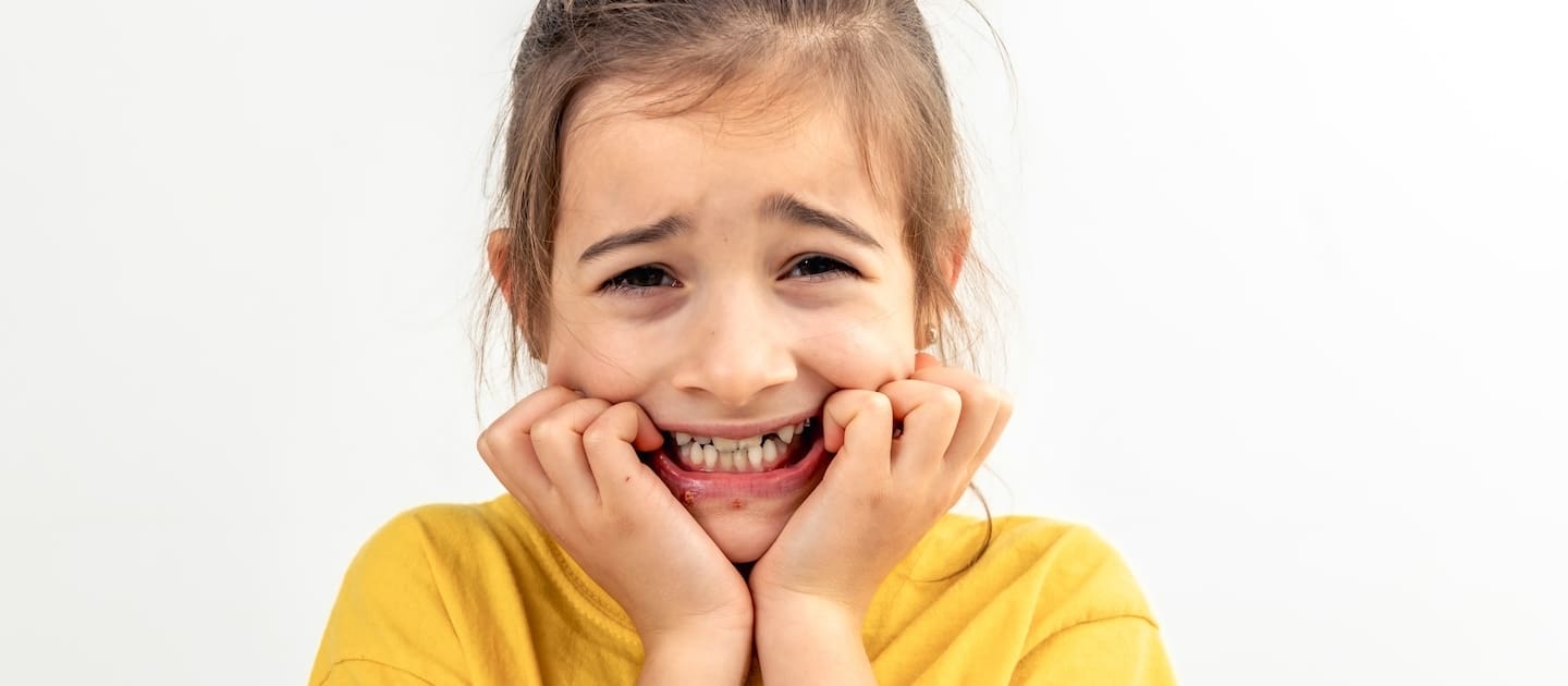 How to prevent an overbite in your child 1 scared anxious girl biting her fingernails white background isolated